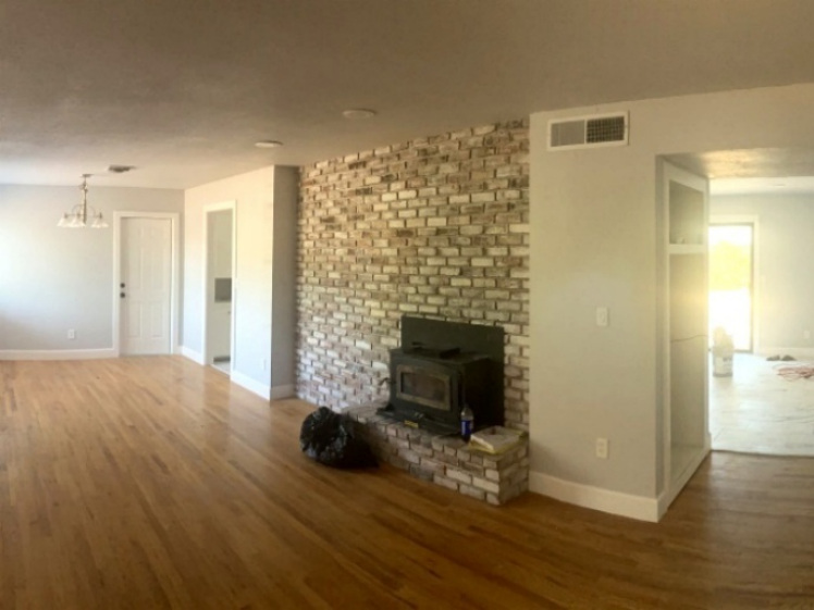 Finished living area with updated brick fireplace wall