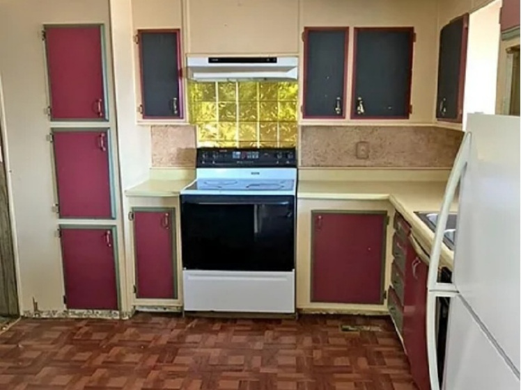 Before kitchen with older maroon cabinets