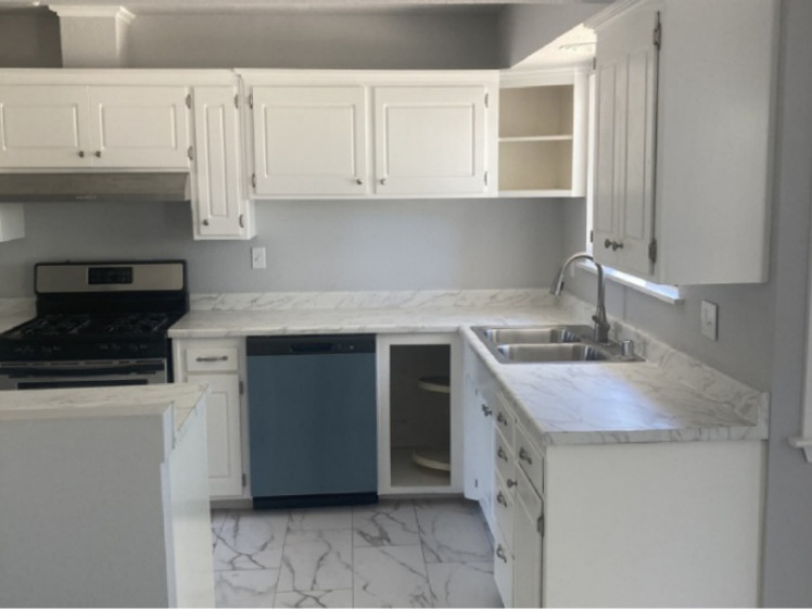 Completed kitchen remodel with white cabinets and updated finishes