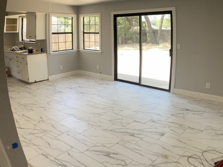 Interior remodel finish work in progress with new tile flooring and sliding door