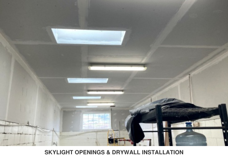 Skylight openings and drywall installation in progress