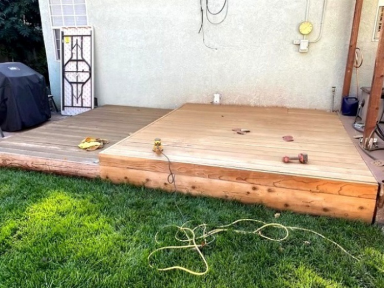New deck construction beside a home exterior