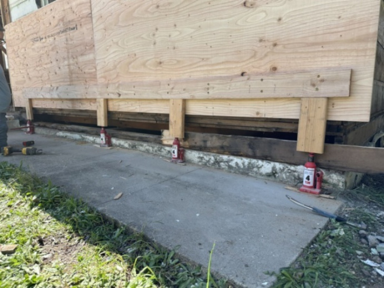 Wall supported with temporary bracing during dry rot repair
