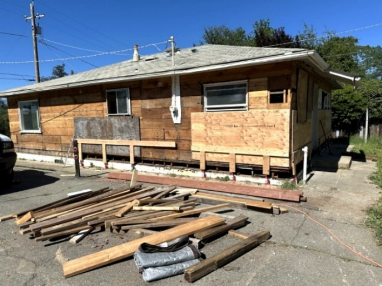 Exterior view showing extensive dry rot repair in progress